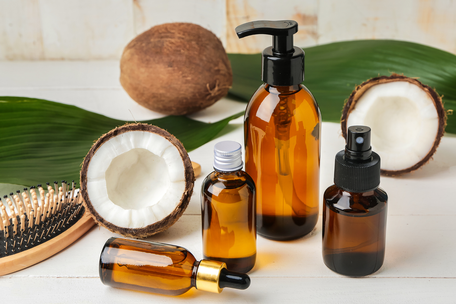 Open coconut with beauty products in brown glass 