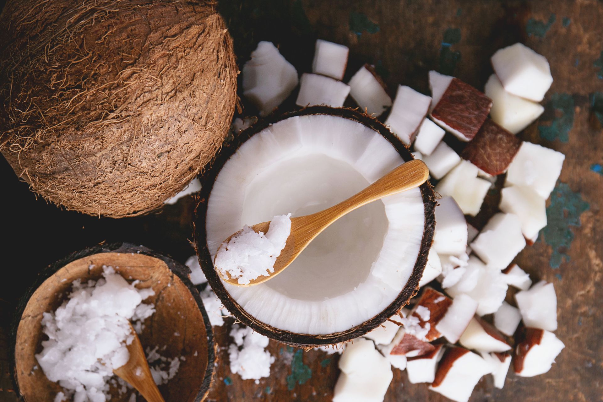 Open coconut with a spoon scooping it out in relation to coconut allergies and intolerances